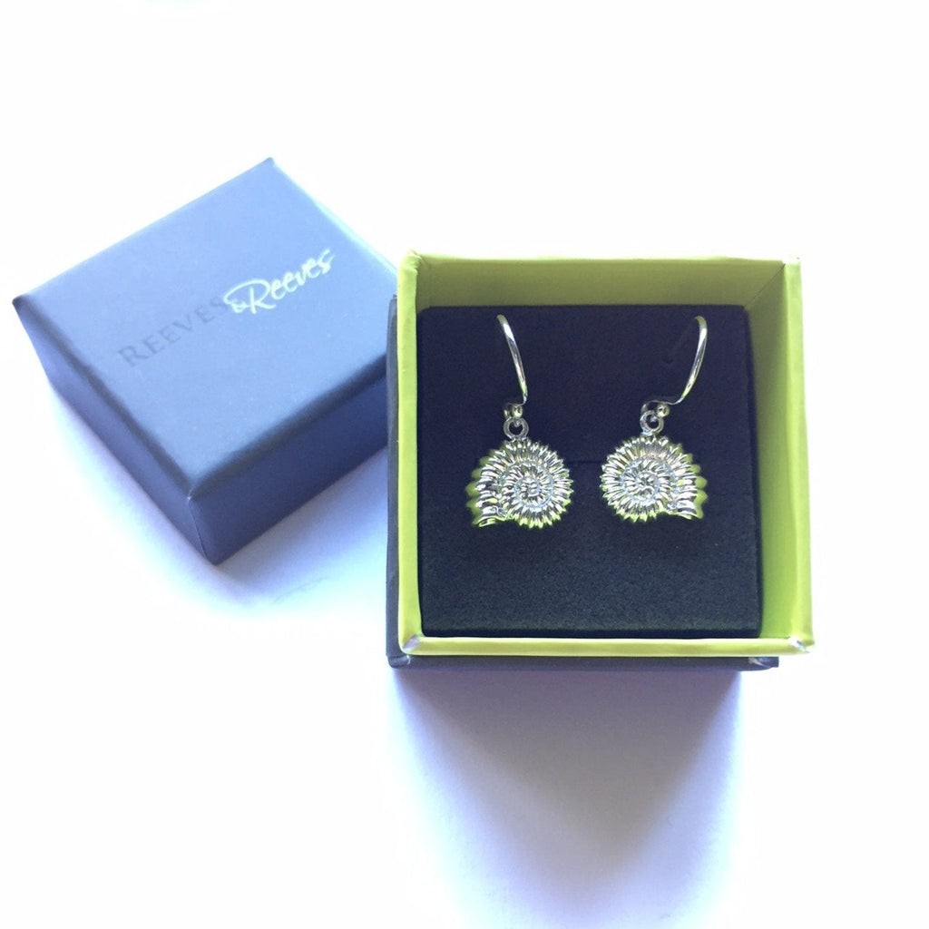 A pair of ammonite drop earrings, on silver hooks and shown in a Reeves & Reeves gift box.