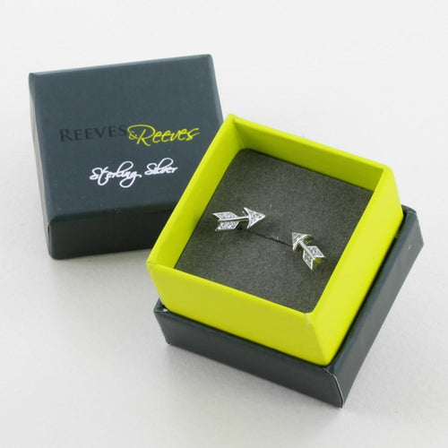 A pair of sterling silver Arrow Stud Earrings filled with cubic zirconia stones and shown in a Reeves & Reeves gift box.
