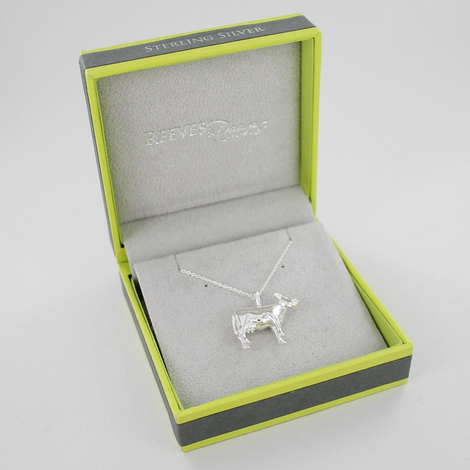 Sterling Silver Cow Necklace, on a silver chain and shown in a Reeves & Reeves gift box.