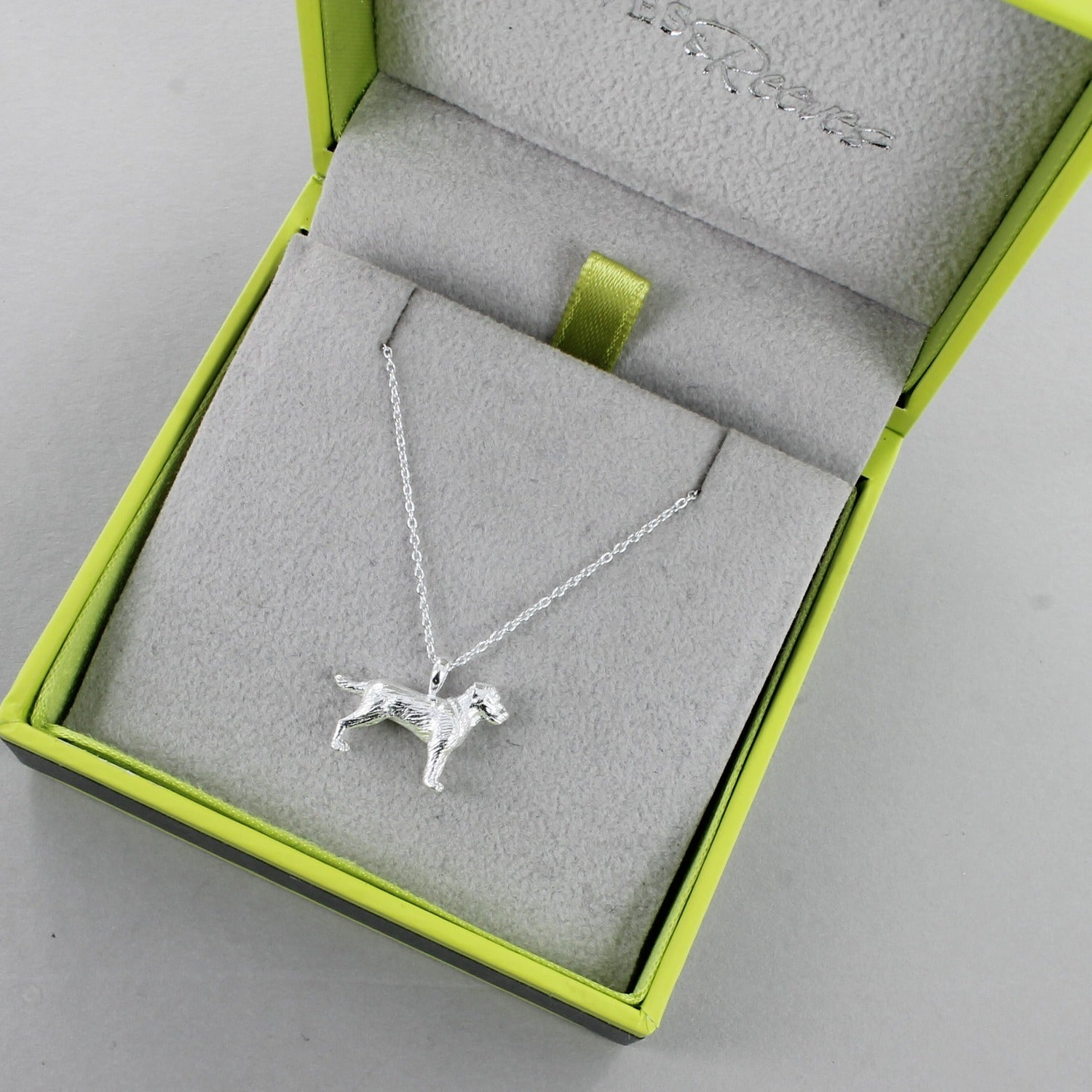 A Sterling Silver Labrador Dog Necklace, on a silver chain and shown in a Reeves & Reeves grey and green branded gift box.