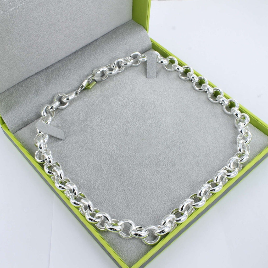 A sterling silver classic statement link necklace in a continuous design, shown in a Reeves & Reeves grey and green gift box.
