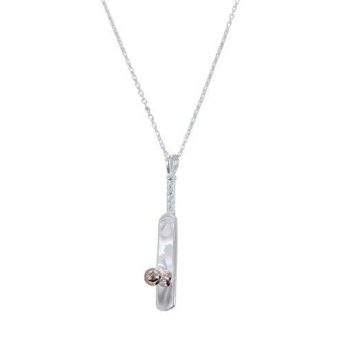 A sterling silver necklace featuring a three-dimensional cricket bat design with a cricket ball detail in rose gold vermeil, suspended from a silver chain.