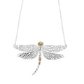 A Sterling Silver Dazzling Dragonfly Necklace, with cut out wings and 18ct yellow and rose gold plate detailing on its body. The dragonfly is hung centrally by the tips of its wings on a silver chain.