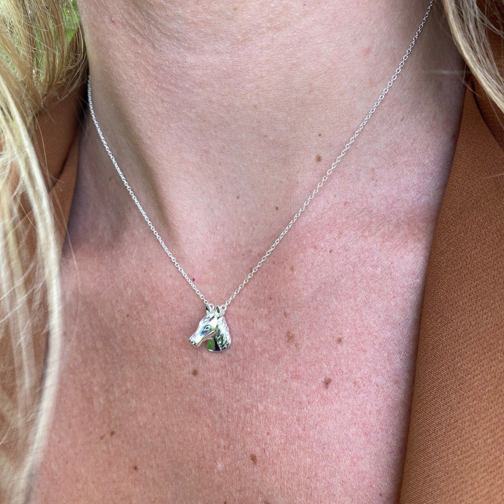 Sterling Silver Horse Head Necklace, sat centrally on a fine silver chain and worn on a models neck.