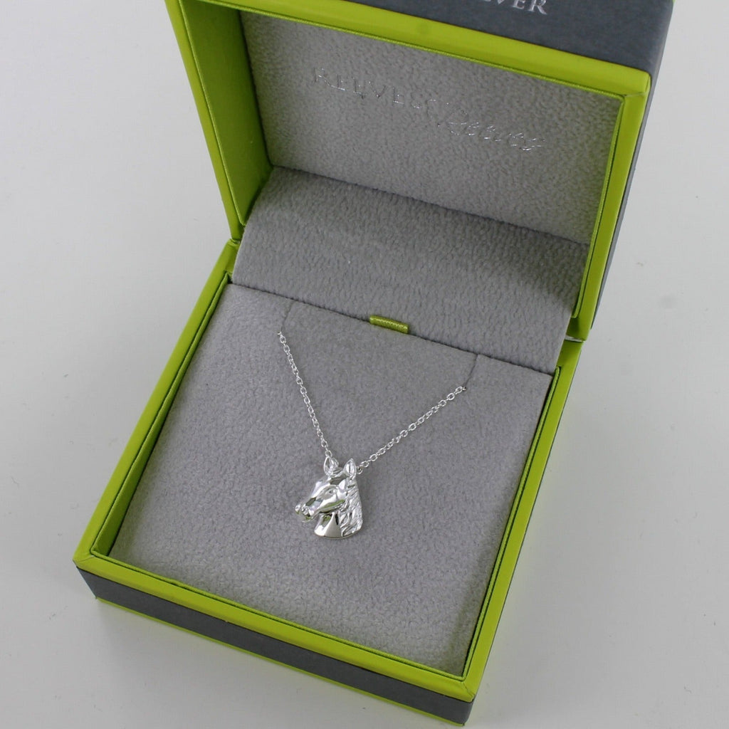 A Sterling Silver Horse Head Necklace on a silver chain and shown in a Reeves & Reeves grey and green branded gift box.