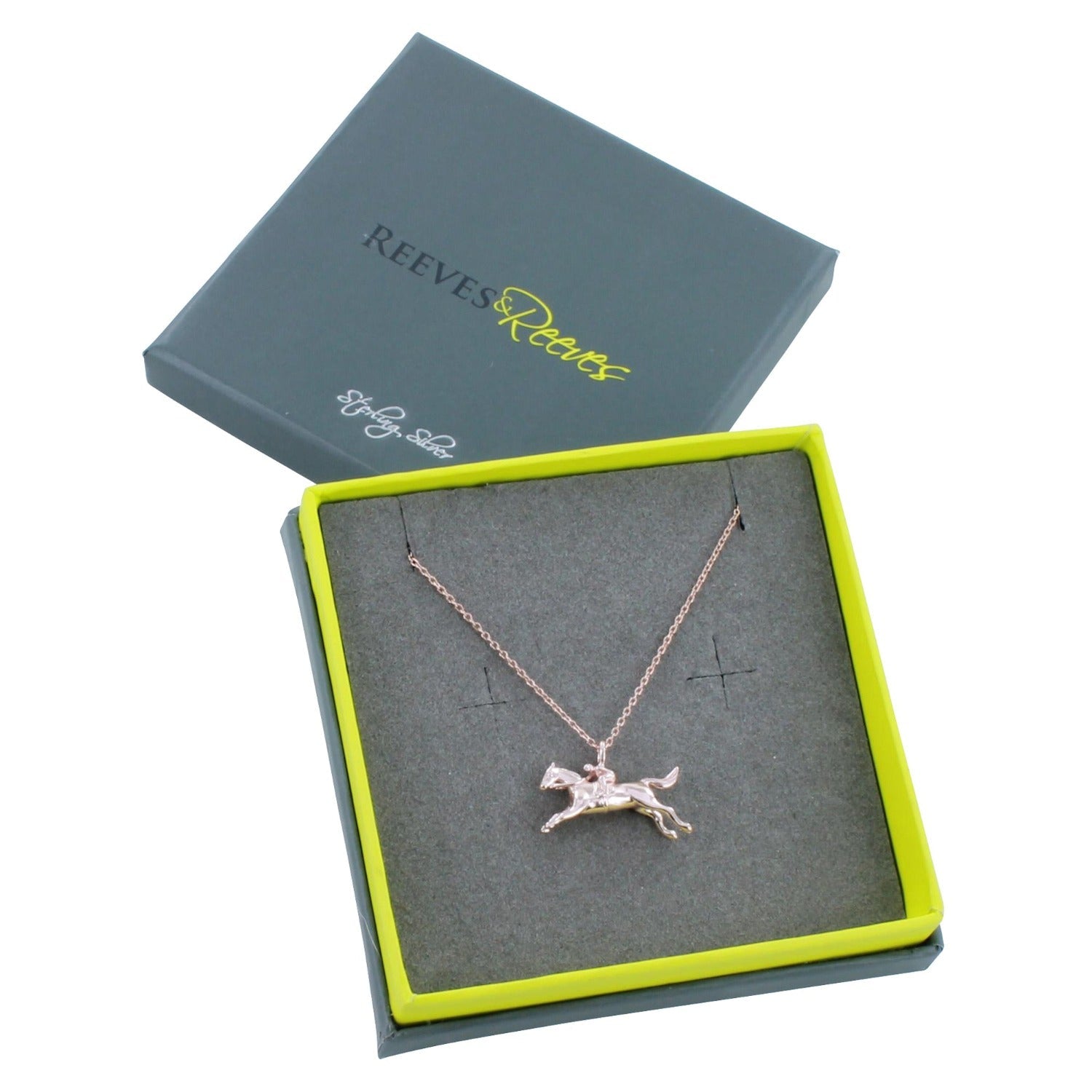 Sterling Silver Racing Horse Necklace shown in a Reeves & Reeves branded gift box which is grey and green.