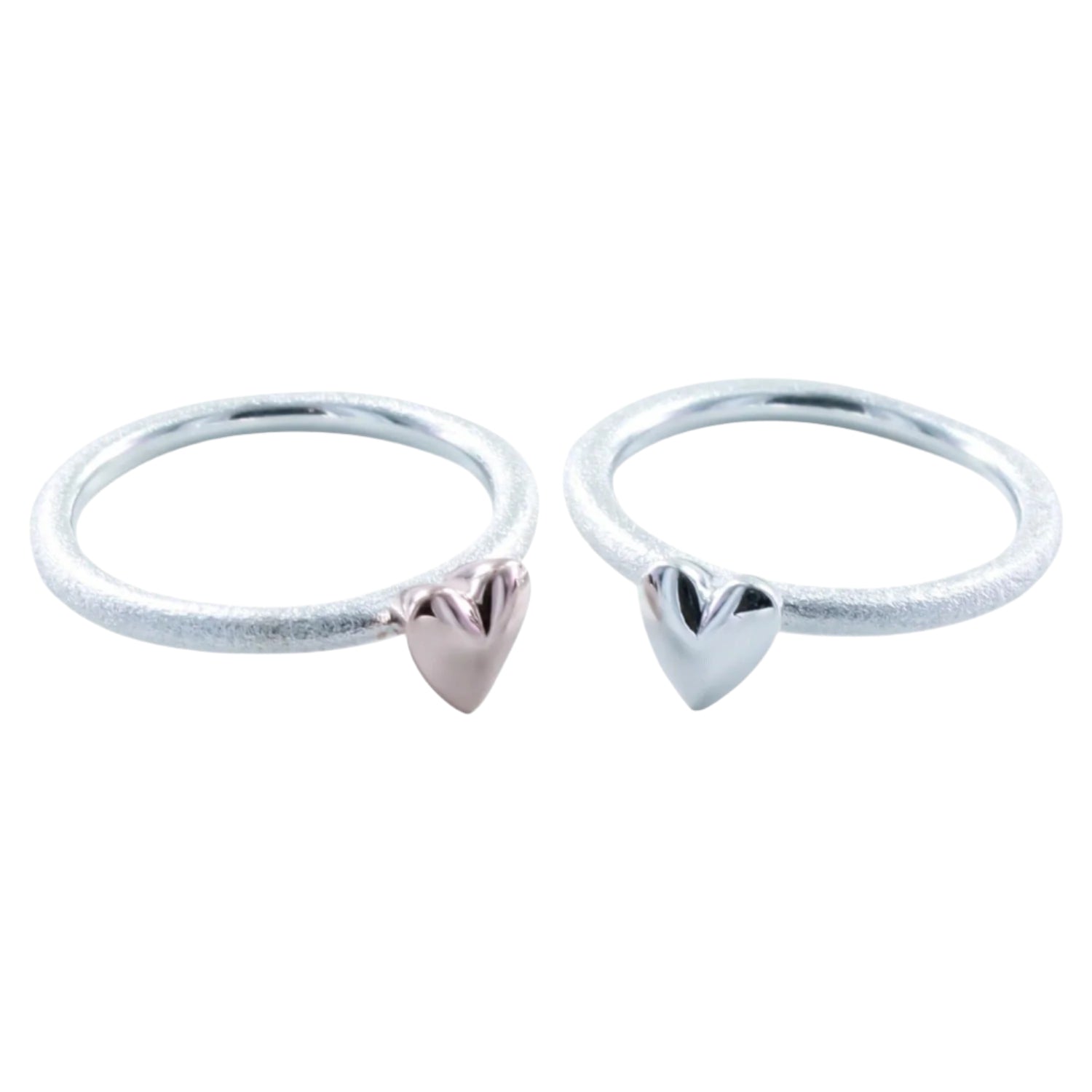 Two silver matt rings, one with a silver 3D heart and one with an 18ct rose gold heard on the band.