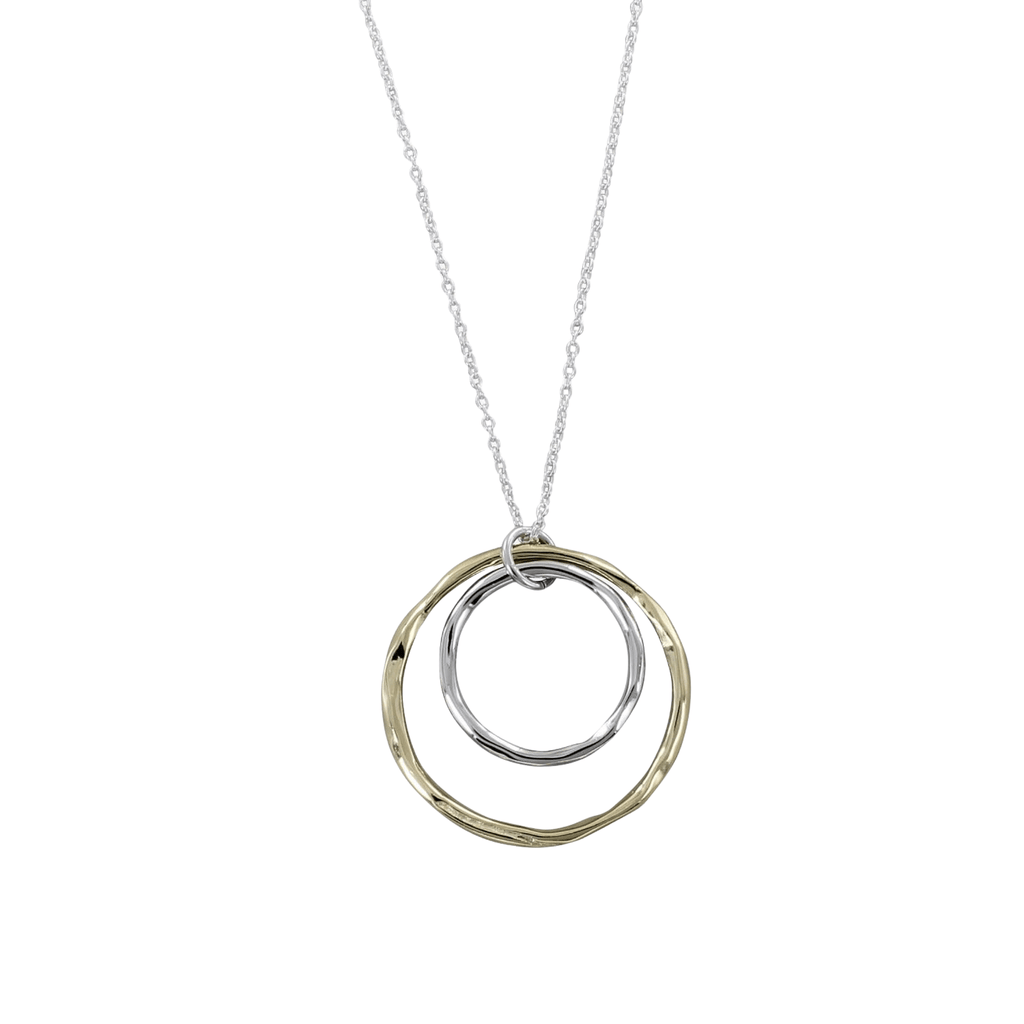 A Sterling Silver disc with a larger gold plated disc surrounding it. Both discs hang centrally on a silver adjustable chain.