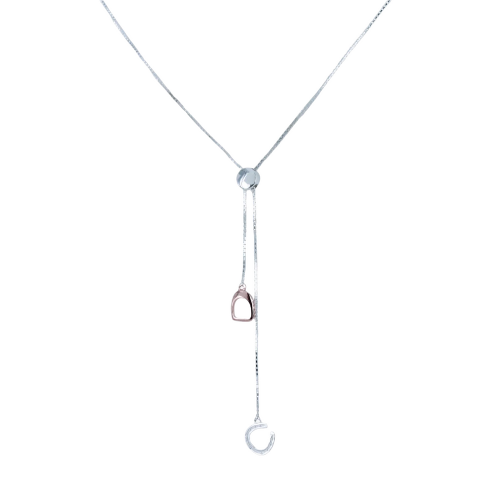 A Silver pull through style necklace, with a horseshoe and stirrup charm dangling on the silver chain.