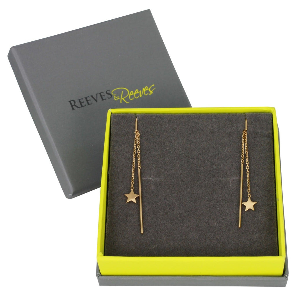 A pair of pull through earrings in sterling silver and 18ct gold plate, with a star charm hanging at the end of a chain and shown in a Reeves & Reeves gift box.