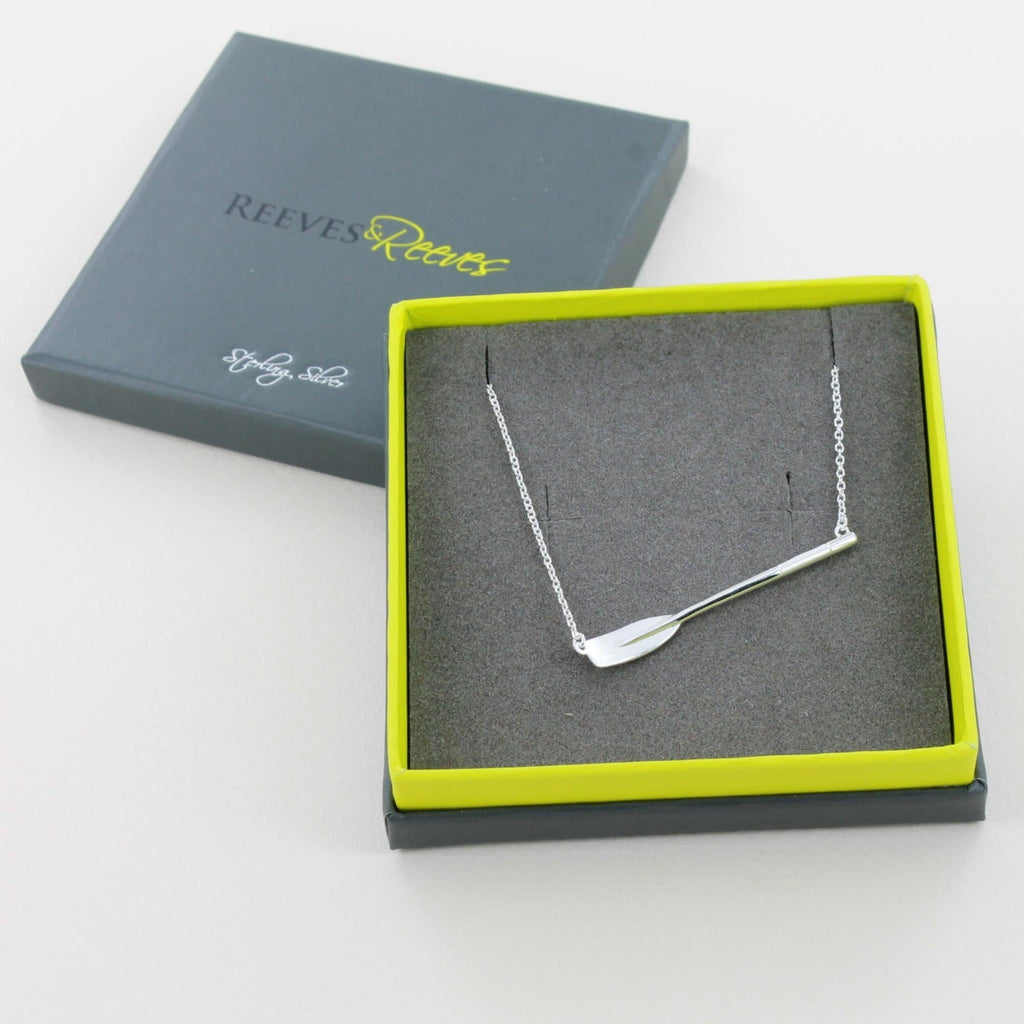 Sterling Silver Gig Oar Necklace shown in a Reeves & Reeves grey and green branded gift box.