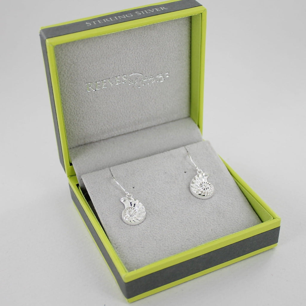 A pair of Sterling Silver Jurassic Ammonite Drop Earrings on silver hooks, shown in a Reeves & Reeves gift box.