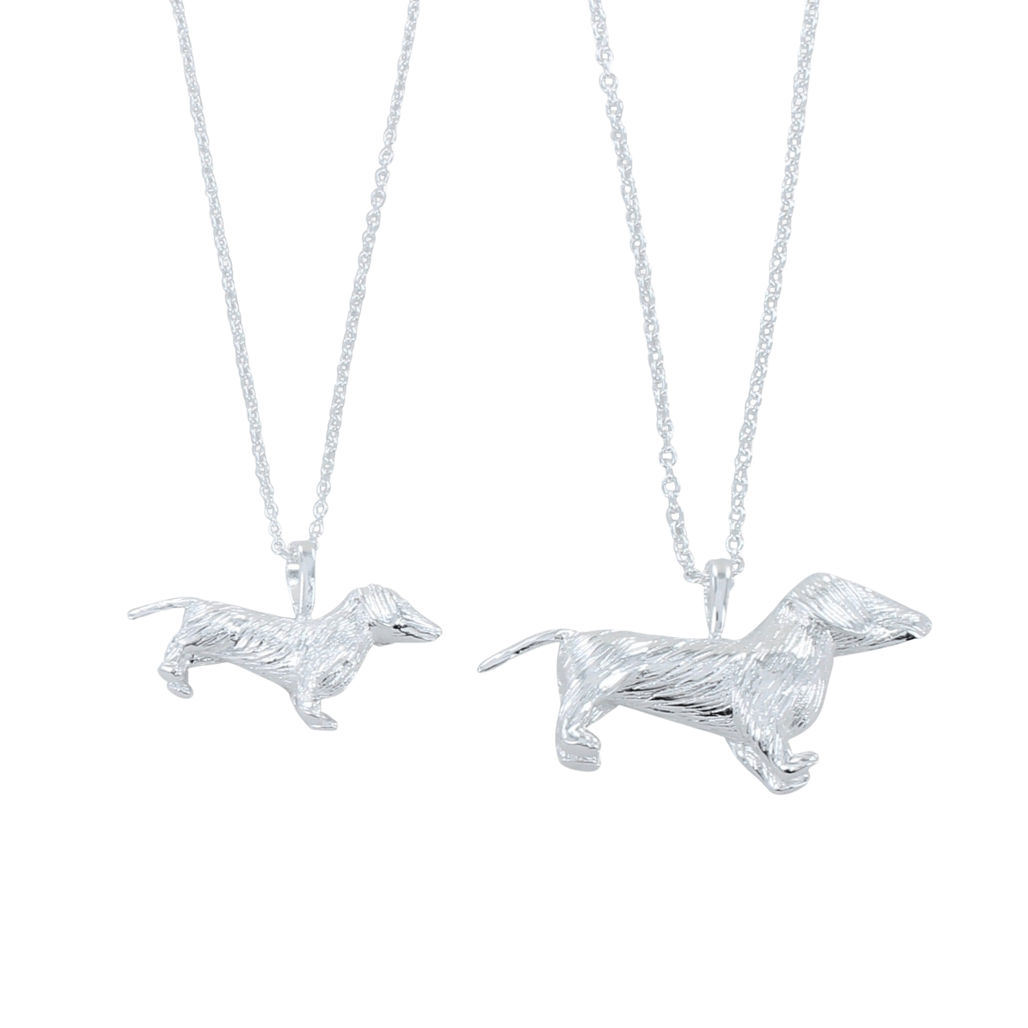 Two silver dachshund pendants, one smaller than the other in size, both hanging on silver adjustable chains.