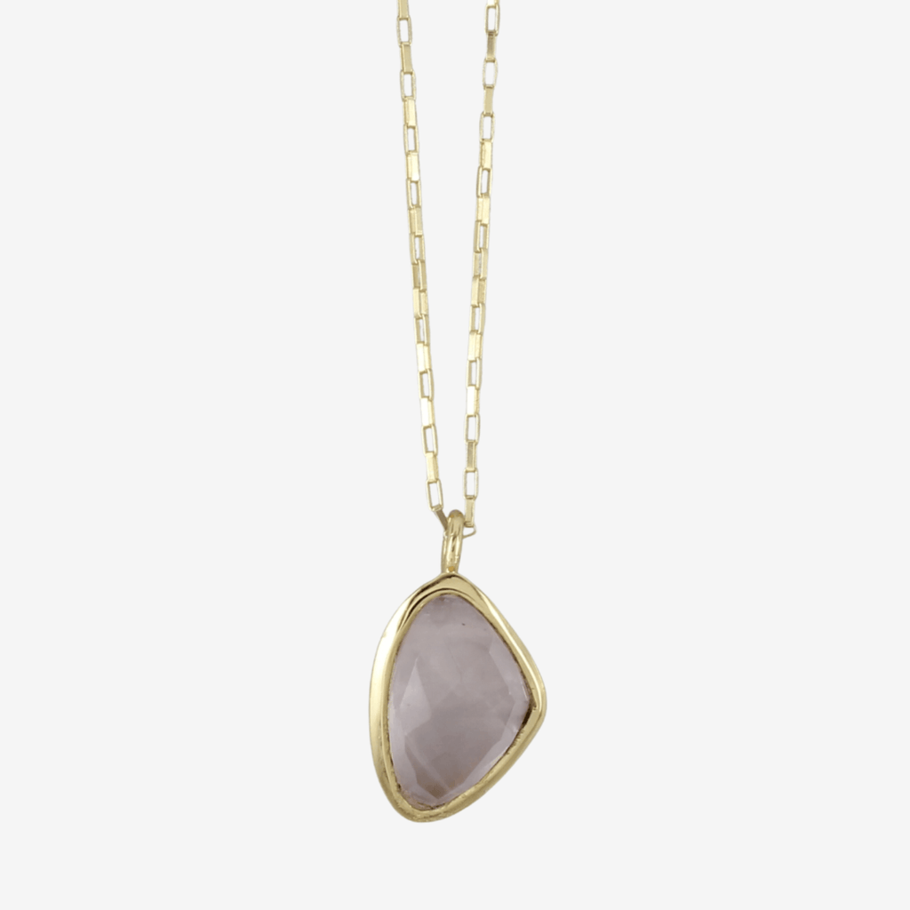 A rose quartz stone, set in gold plating and hung on a gold plated box chain.