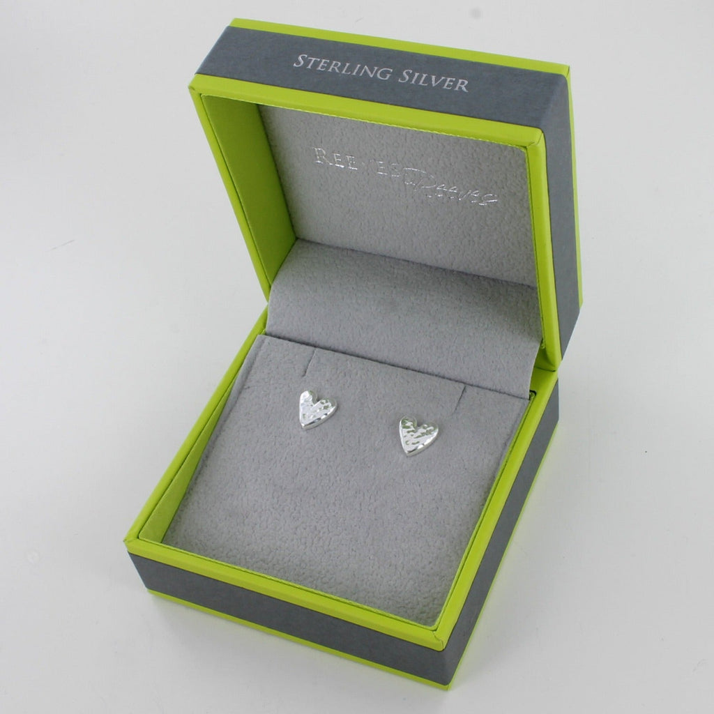 A pair of sterling silver heart studs with a hammered finish. Shown in a Reeves & Reeves gift box.