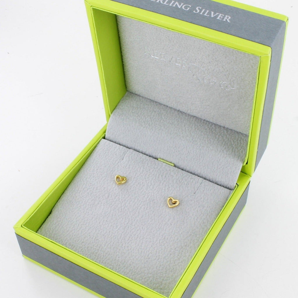 A pair of sterling silver heart silhouette stud earrings in 18ct gold plate, showing in a Reeves & Reeves gift box.