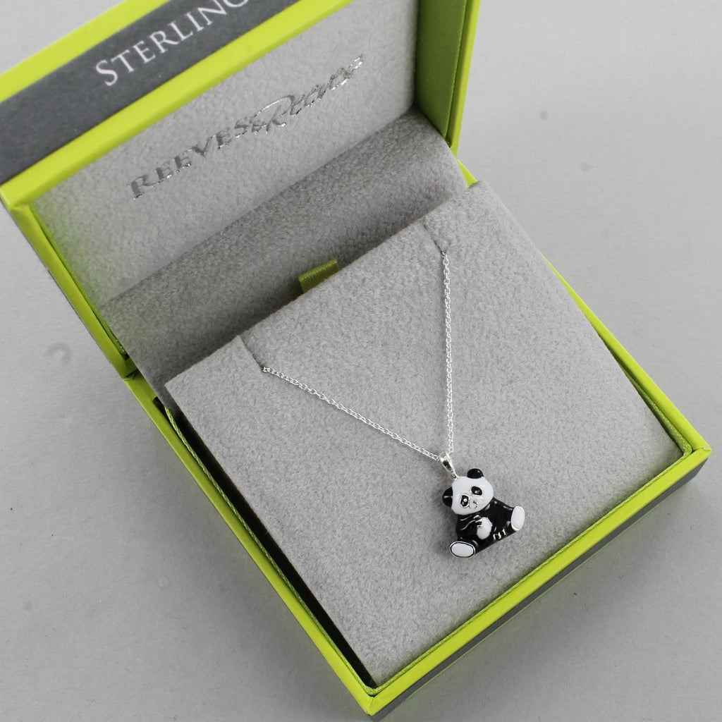 Sterling Silver Panda pendant with black and white enamel finish, hung on a silver chain and shown in a Reeves & Reeves grey and green branded gift box.