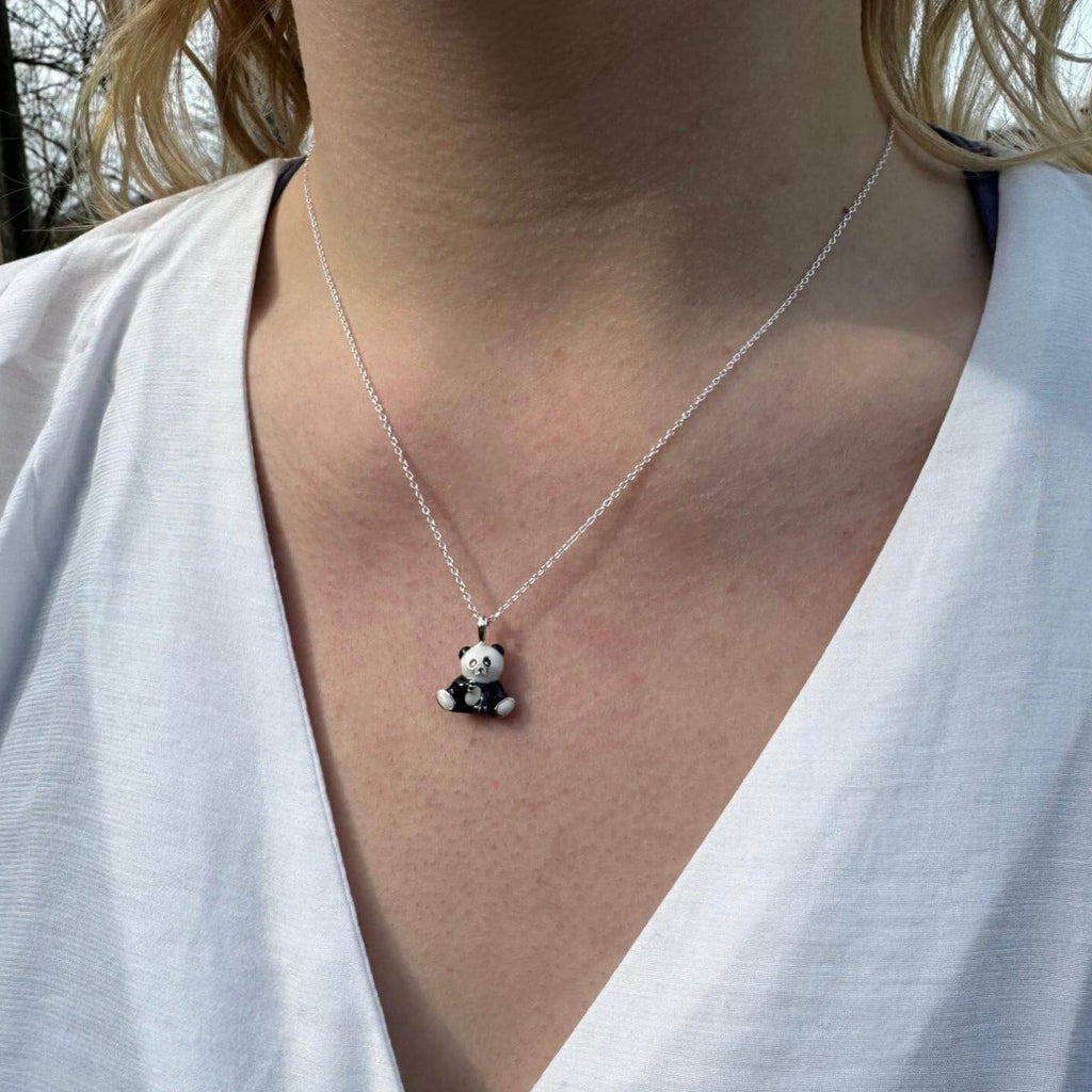 Sterling Silver Panda pendant with black and white enamel finish and hung on a silver adjustable chain, worn on a model.
