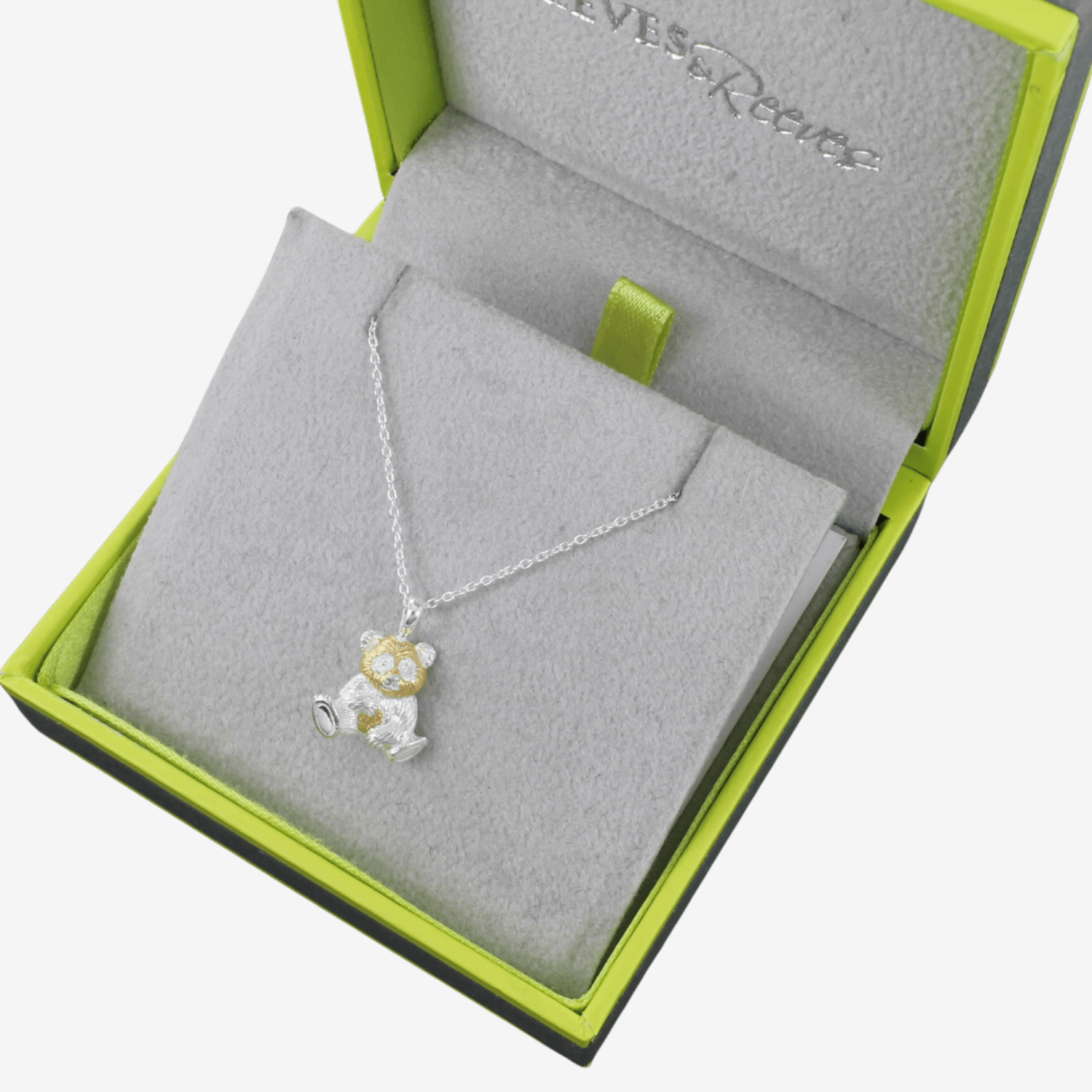 A sterling silver and gold plated Panda Necklace, hanging on a silver adjustable chain and shown in a Reeves & Reeves grey and green branded gift box.