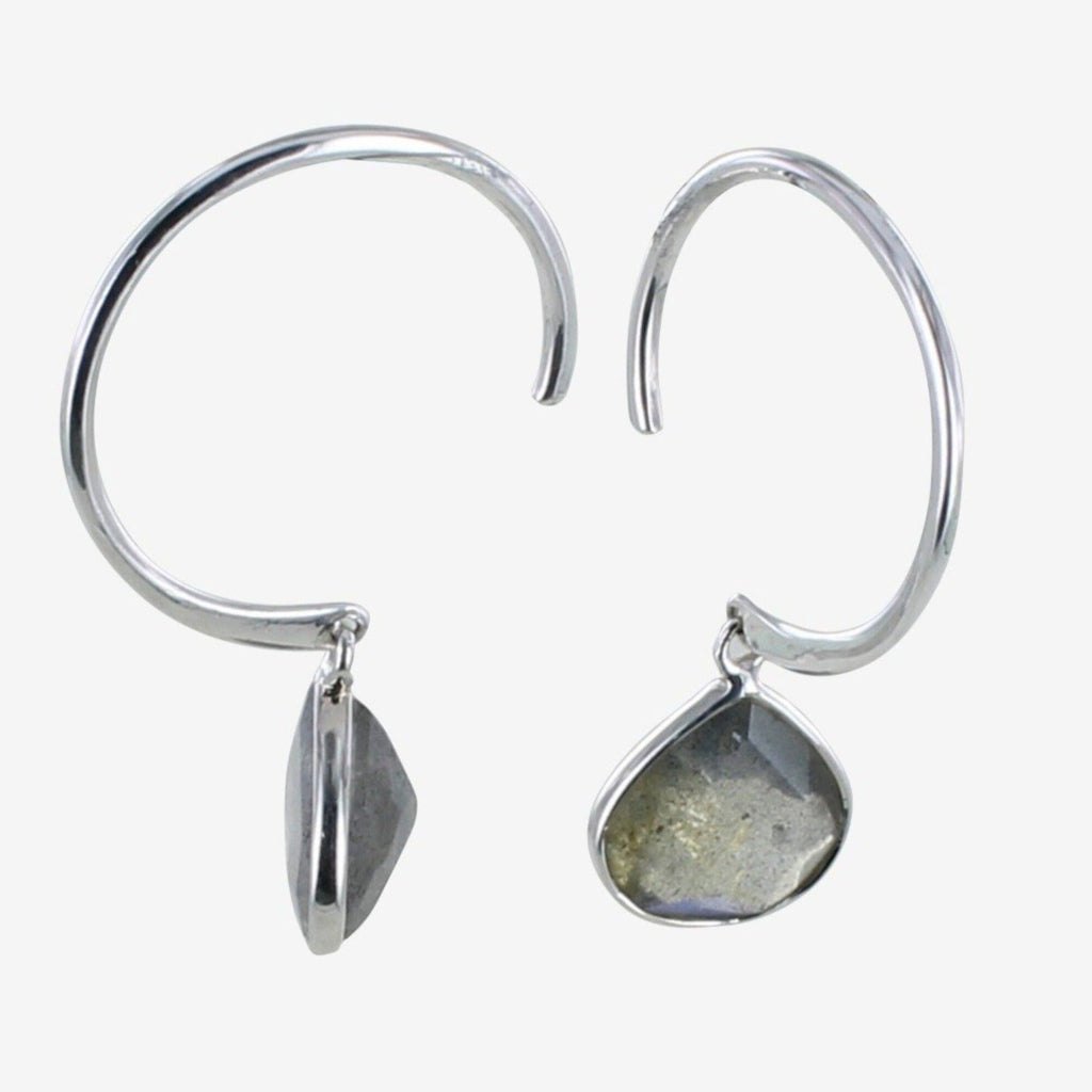 A pair of sterling silver hoop earrings with a pear shaped labradorite stone hanging from the bottom of the hoop.