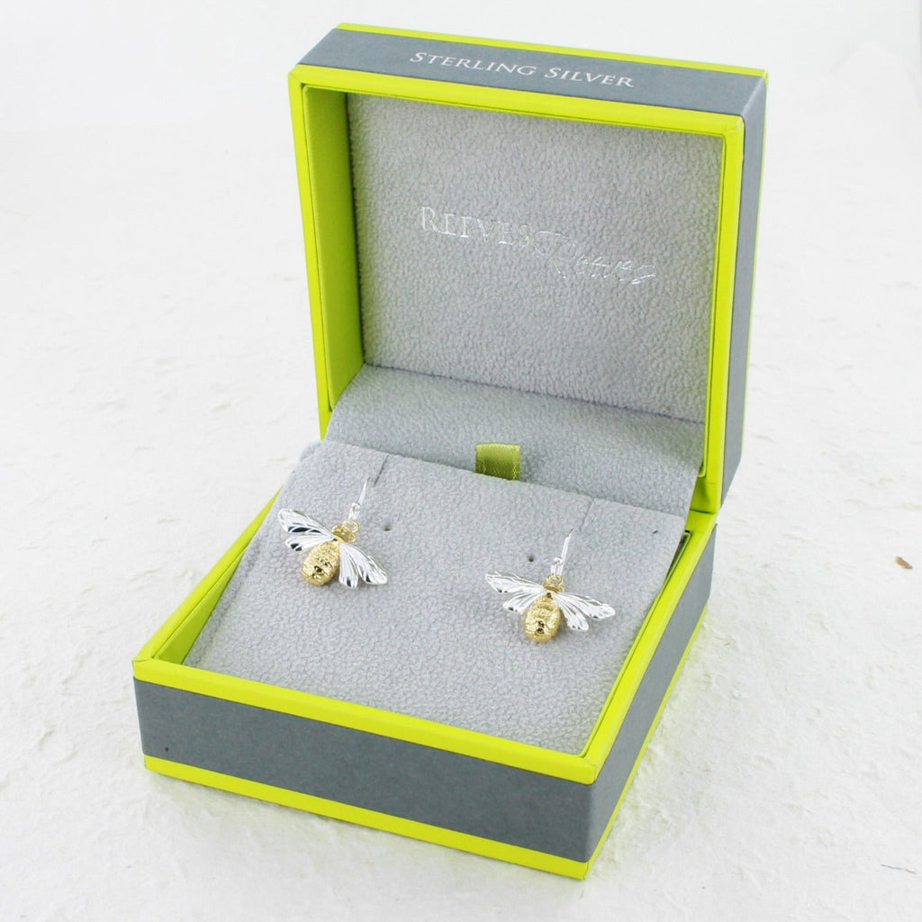 A pair of Queen Bee Drop Earrings, with silver hooks and 18ct gold plating on its body. Shown in a Reeves & Reeves grey and green gift box.