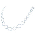 A sterling silver necklace comprised of 'ringlets', circles with undulated edges in a continuous line around the neck.