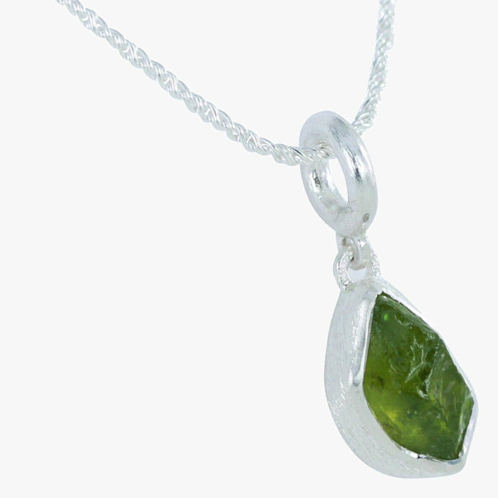 Peridot semi precious stone set in sterling silver and hung on a silver rope style chain.