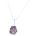 Rough cut Ruby stone, set in sterling silver and hung on a silver rope style chain.