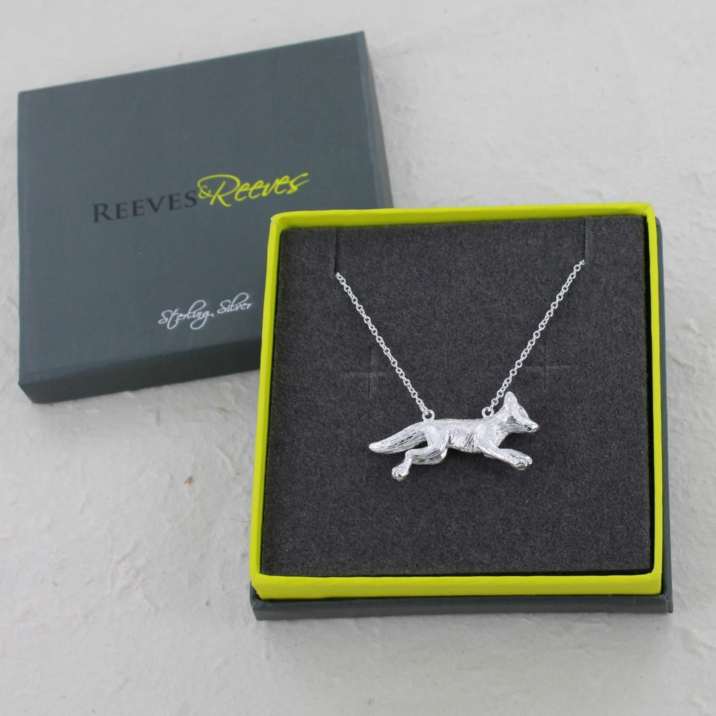 Running Fox Sterling Silver Necklace, shown in a Reeves & Reeves branded grey and green gift box.