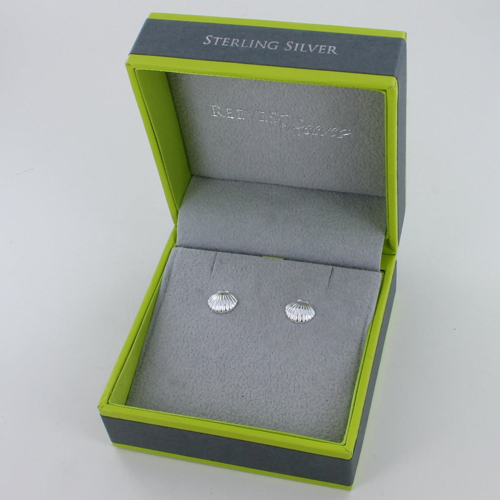 A pair of sterling silver scallop shell stud earrings, shown in a Reeves & Reeves gift box.