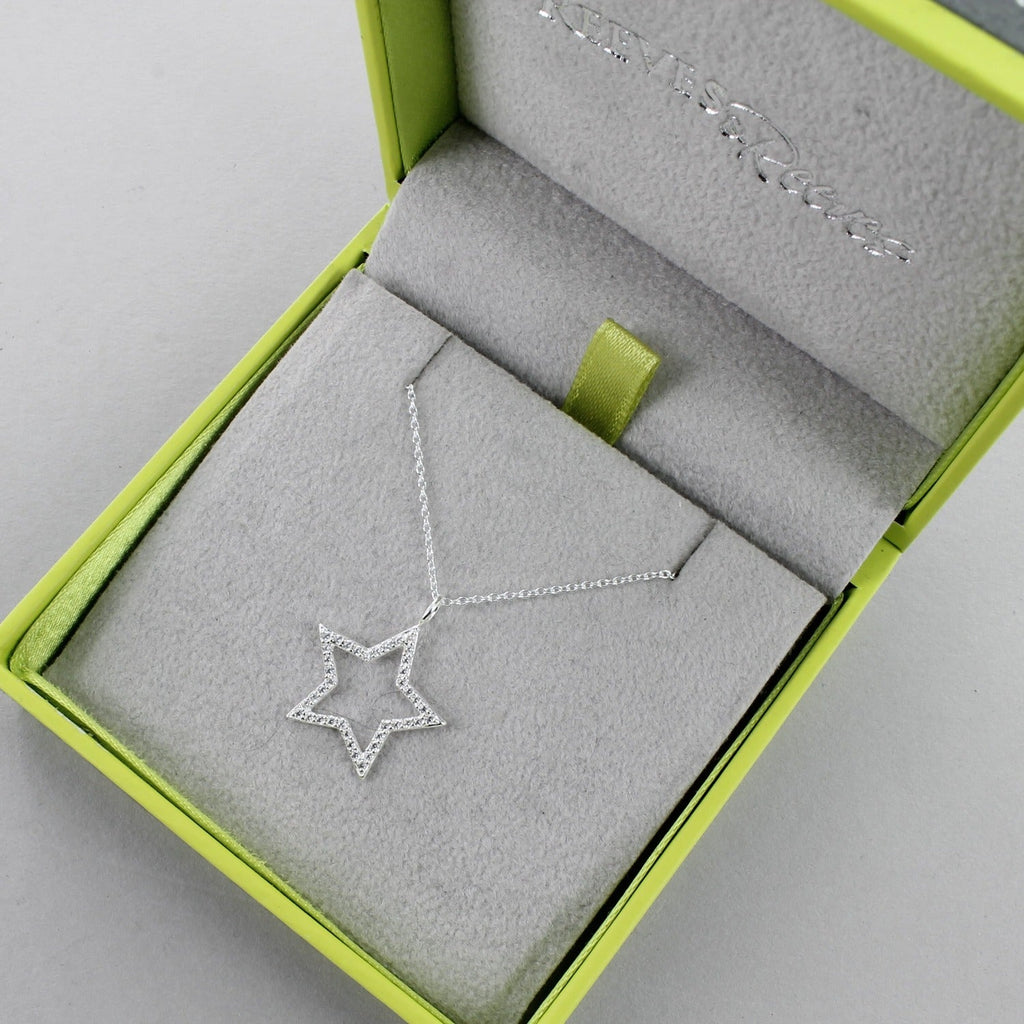 A Silver Star Silhouette Necklace, shown in a Reeves & Reeves grey and green branded box.