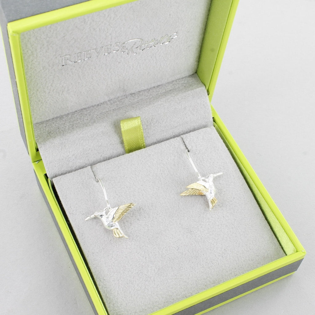 A pair of sterling silver and 18ct gold plated hummingbird drop earrings, shown in a Reeves & Reeves gift box.