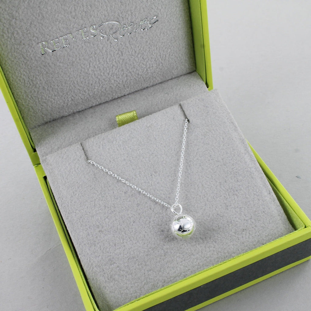 A sterling silver football pendant, shown on an adjustable silver chain and in a Reeves & Reeves grey and green branded gift box.