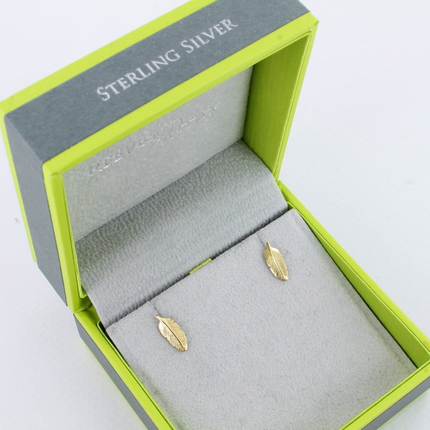 A pair of sterling silver feather studs, in silver and 18ct gold plate and shown in a Reeves & Reeves gift box.
