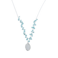 A silver chain necklace with an oval shaped moonstone hanging from the centre of the chain. Small Aqua chalcedony stones sit in clusters up either side of the chain.