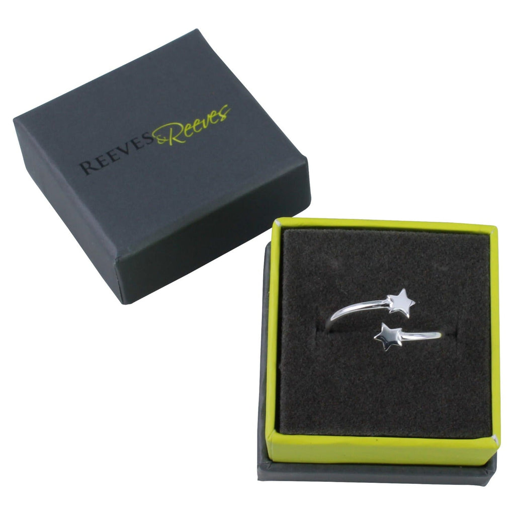 A silver adjustable ring with stars at either end, shown in a Reeves & Reeves grey and green branded gift box.