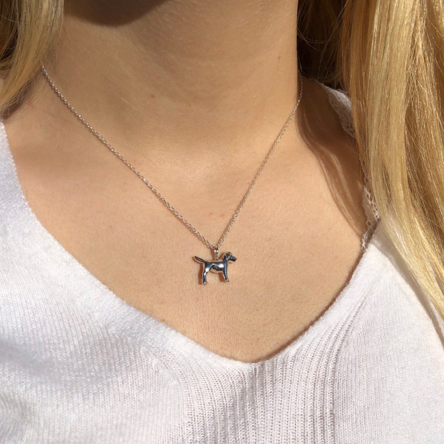 Sterling Silver Dog Pendant on a silver chain and worn on a models neck.