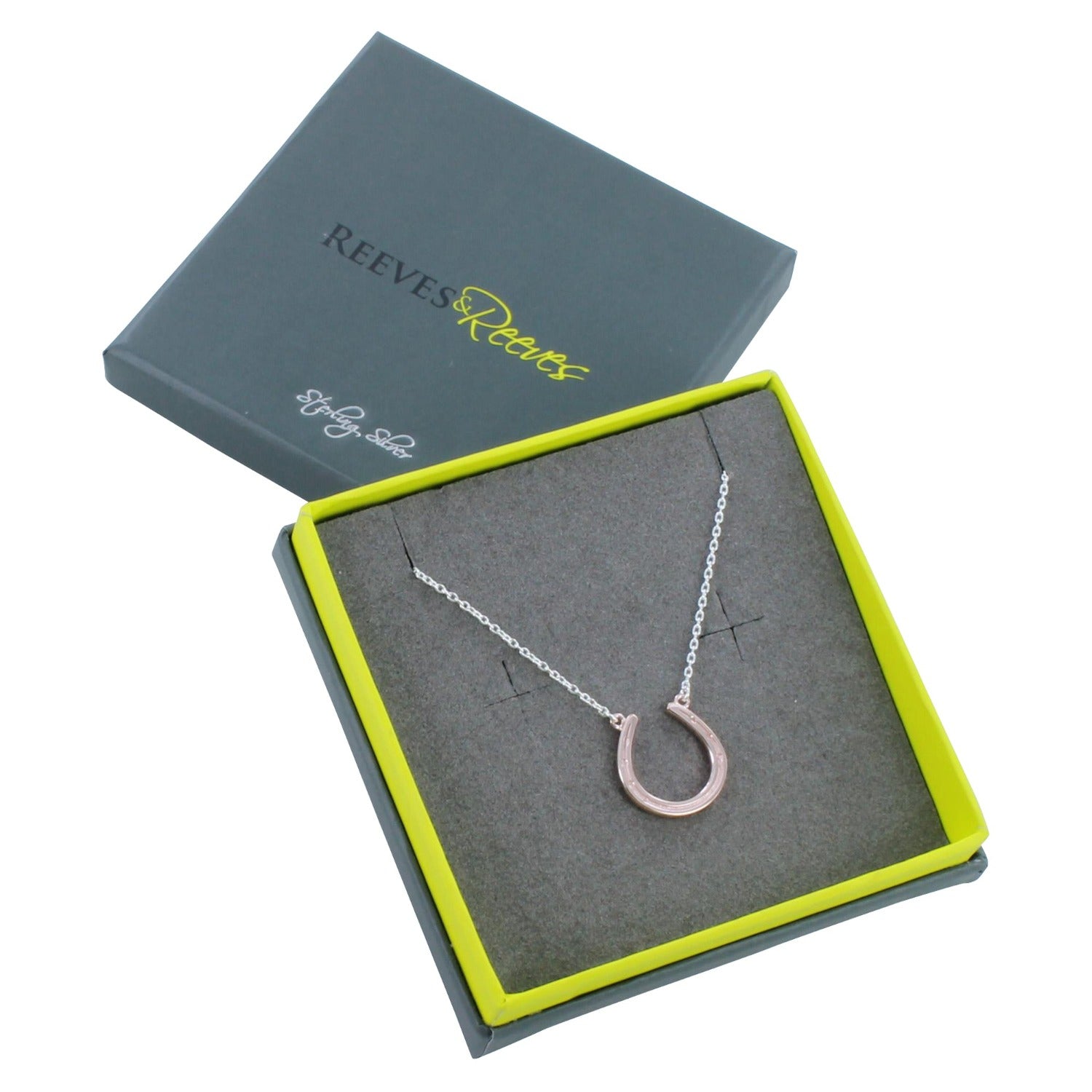 Sterling Silver and rose gold plate horseshoe necklace, hung on a silver adjustable chain. Shown in a Reeves & Reeves grey and green branded gift box.