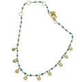 Fine chain bracelet with turquoise beads and gold plated on silver disc charms hanging from the chain. Finished with a lobster style clasp.