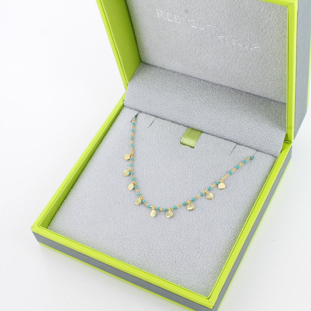 Silver and gold plated turquoise enamel necklace in a branded Reeves & Reeves gift box which is grey and green.