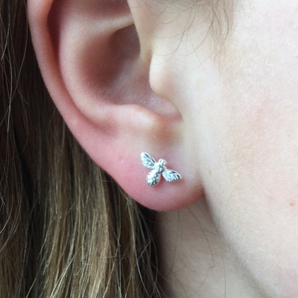 A sterling silver Bumble Bee Stud Earring, worn in a ladies ear.