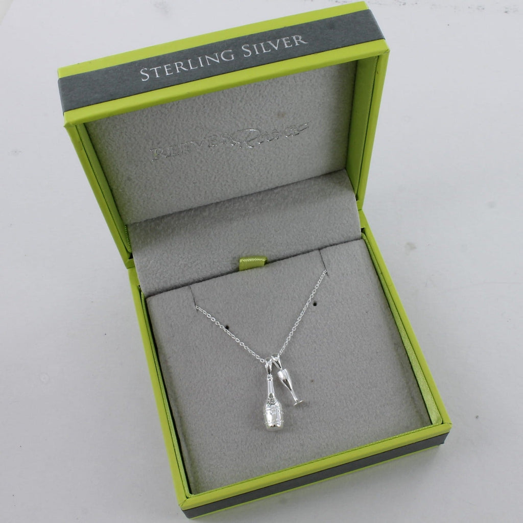 Sterling Silver champagne bottle with a glass charm, sat next to each other on a silver chain and shown in a Reeves & Reeves grey and green gift box.