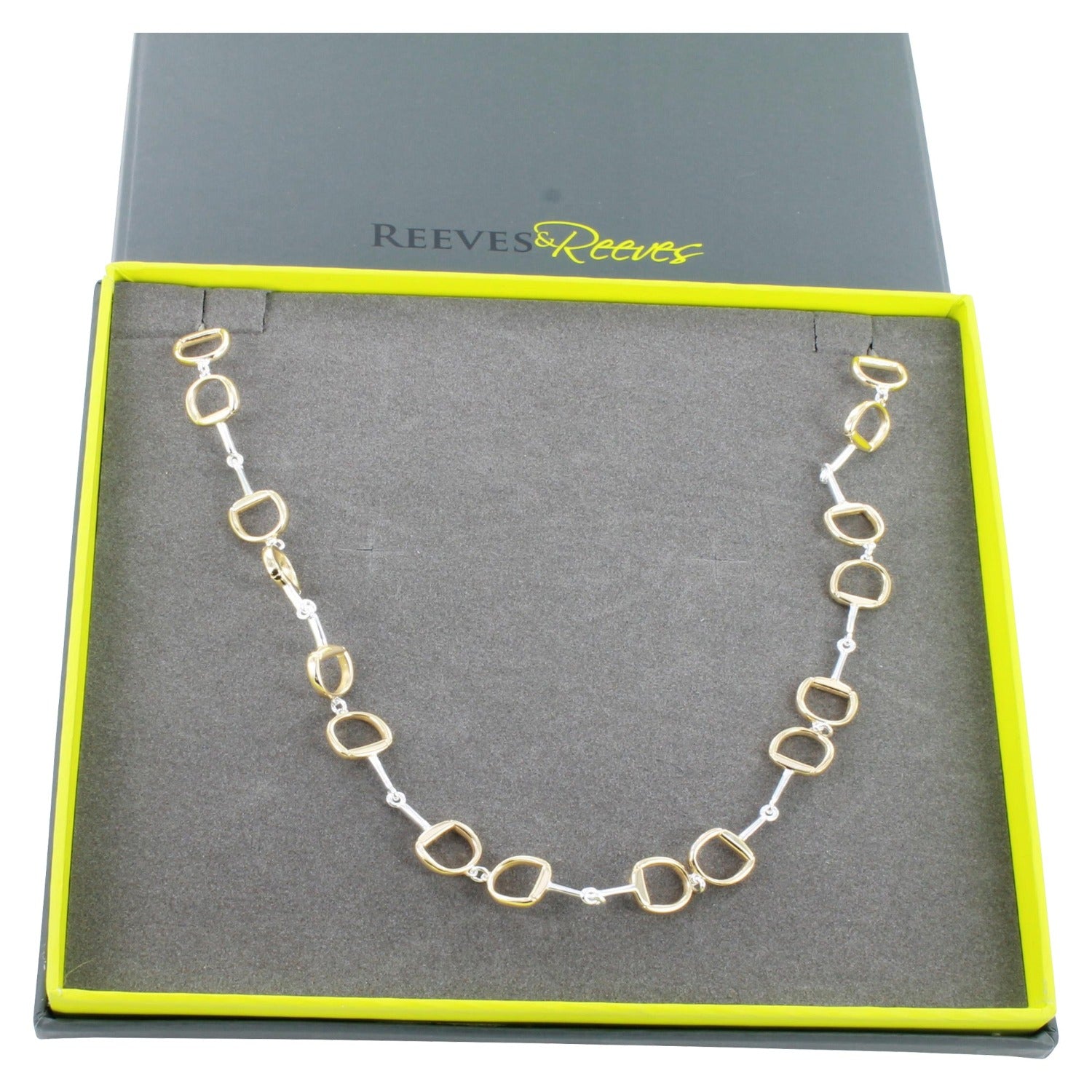 Silver and gold plate continuous snaffle necklace shown in a Reeves & Reeves grey and green branded gift box.