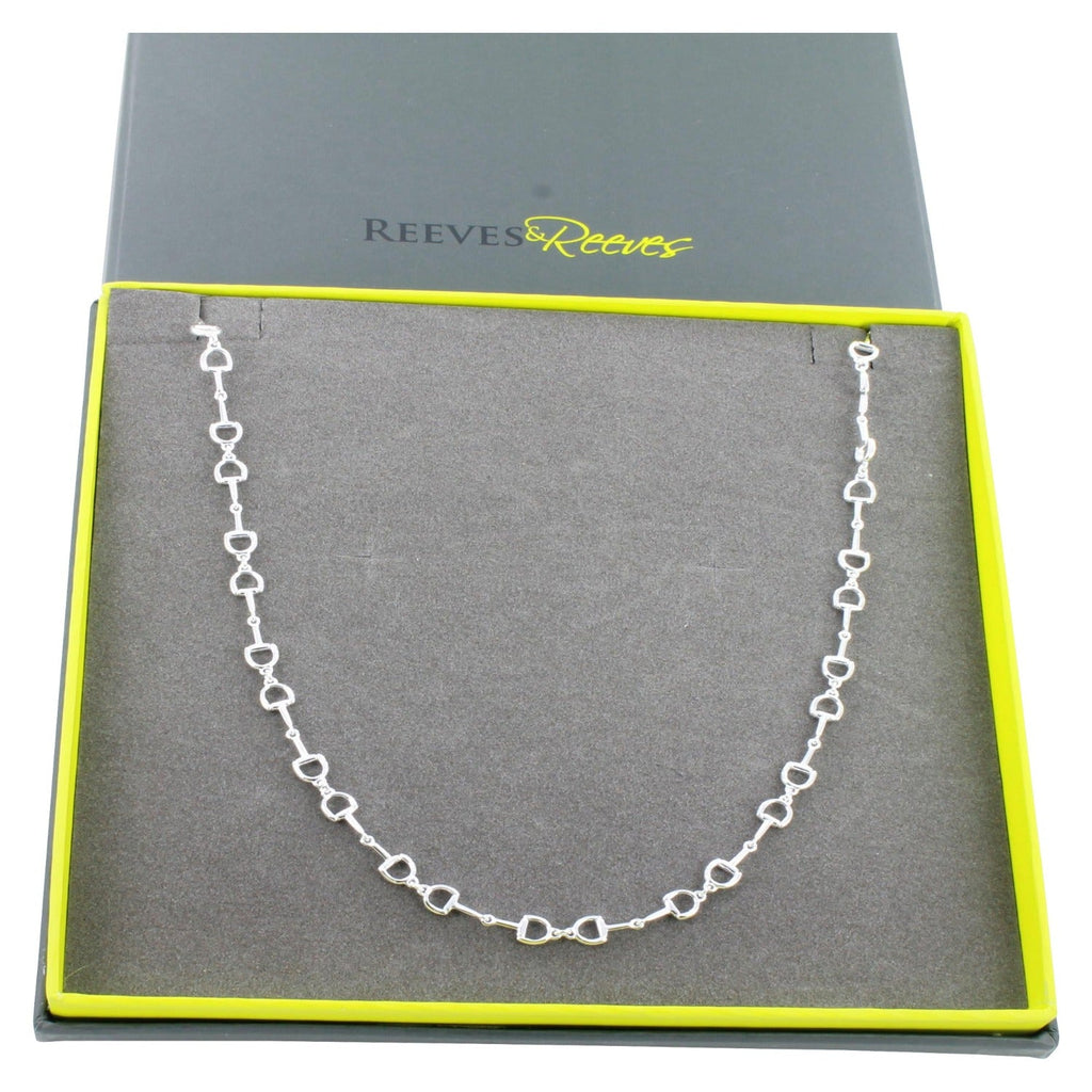 A Sterling Silver Continuous Snaffle Necklace, shown in a grey and green Reeves & Reeves branded gift box.