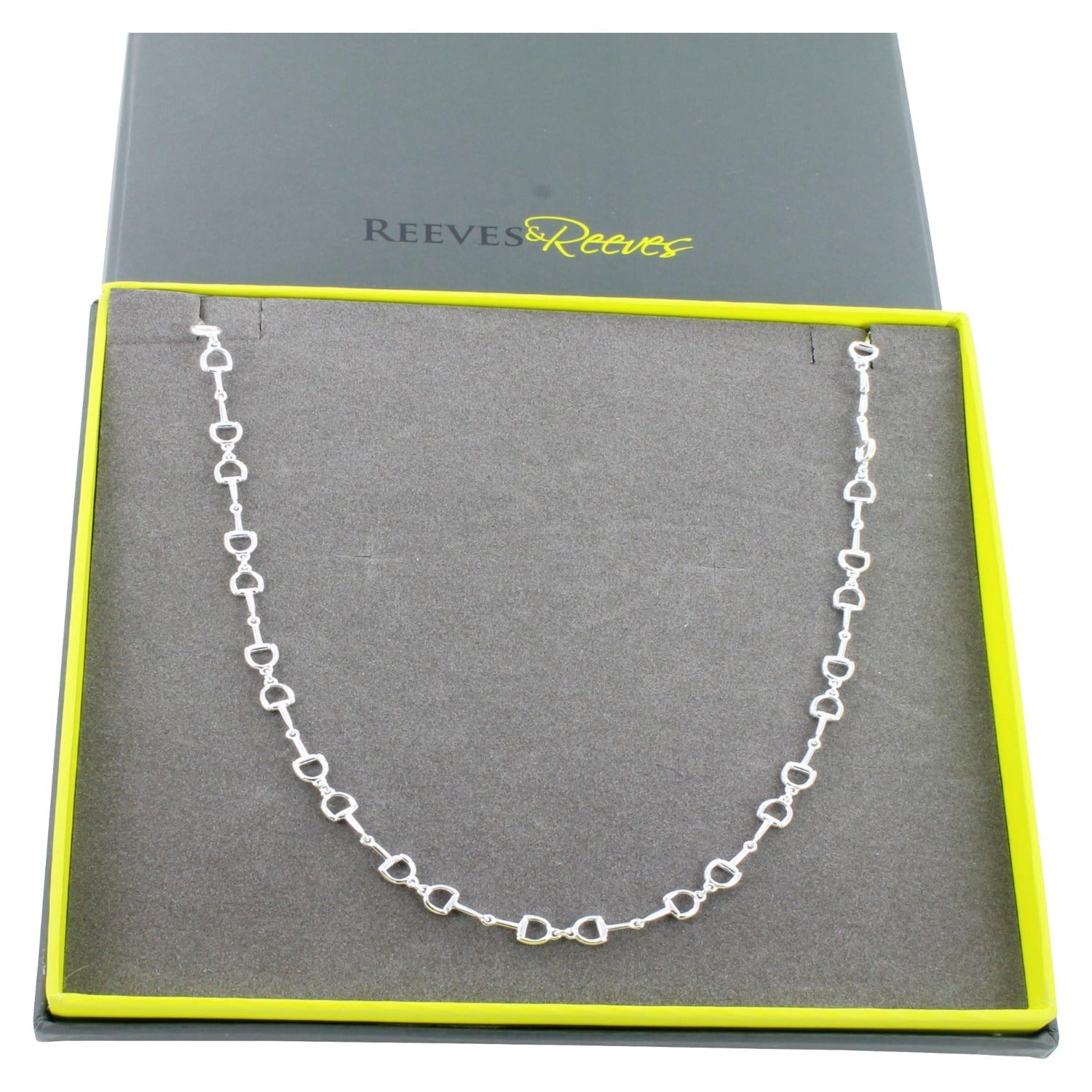 A Sterling Silver Continuous Snaffle Necklace, shown in a grey and green Reeves & Reeves branded gift box.