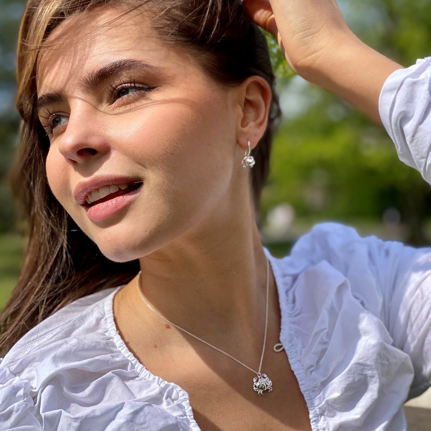 Sterling Silver Crab Necklace worn on a ladies neck with a white blouse.