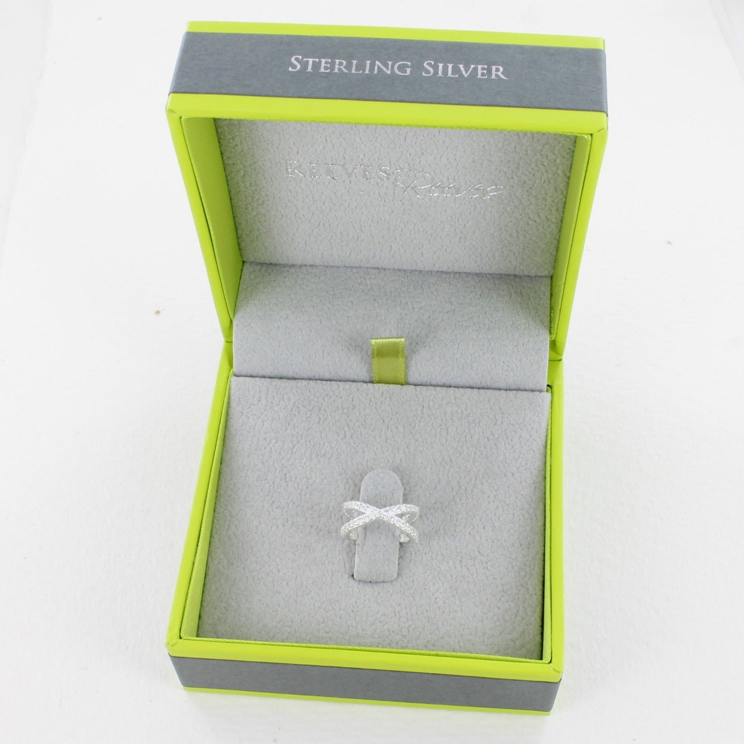A sterling silver ear cuff, filled with cubic zirconia stones and shown in a Reeves & Reeves gift box.