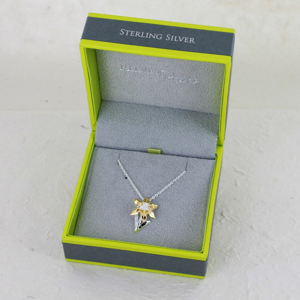 Sterling Silver Daffodil Necklace with gold plated leaves, hung on a silver chain and shown in a Reeves & Reeves gift box.