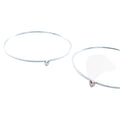Two fine silver bangles, one with a silver heart and one one with a rose gold heart.
