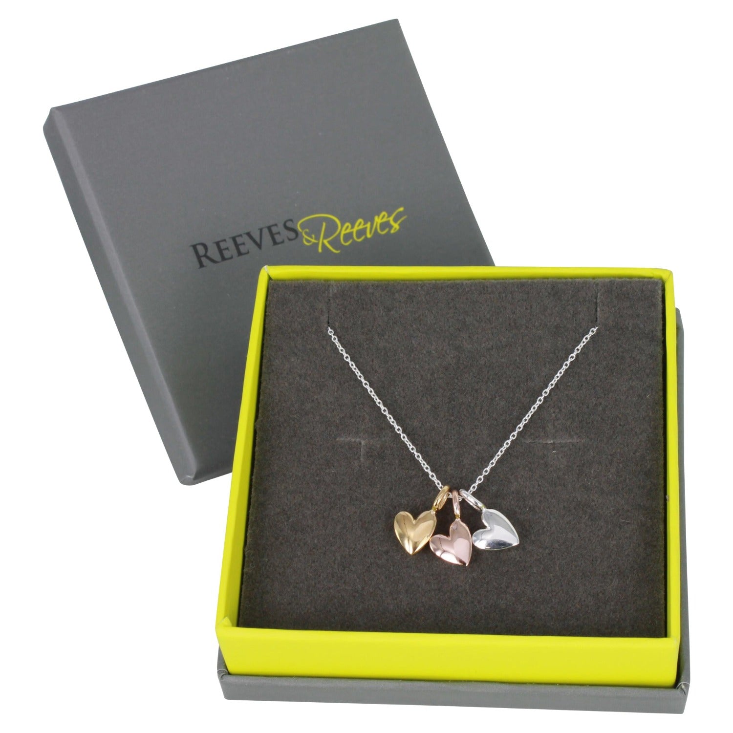 Trio of hearts necklace shown in a Reeves & Reeves branded grey and green box.
